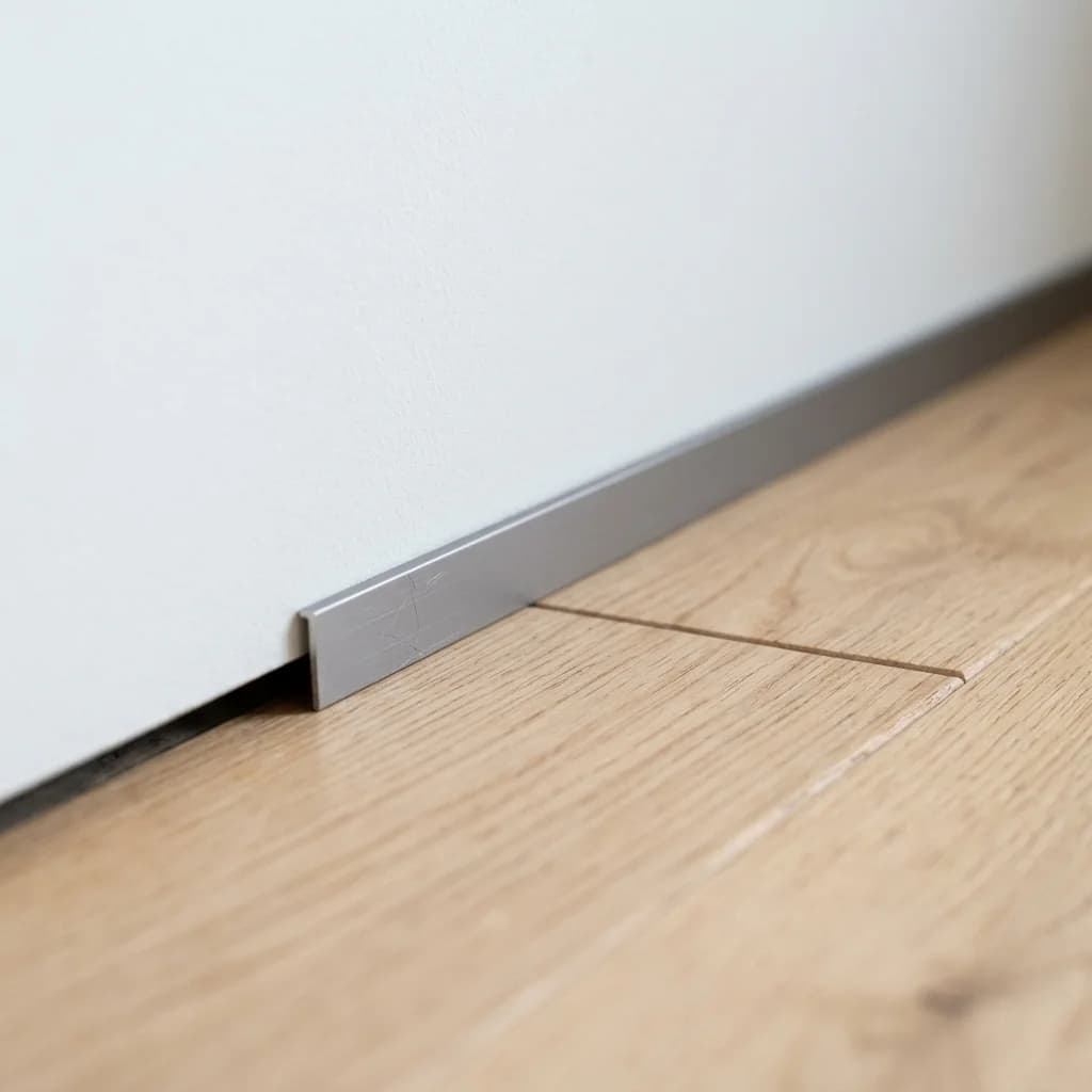 Aluminum micro-baseboard trim between floor and wall